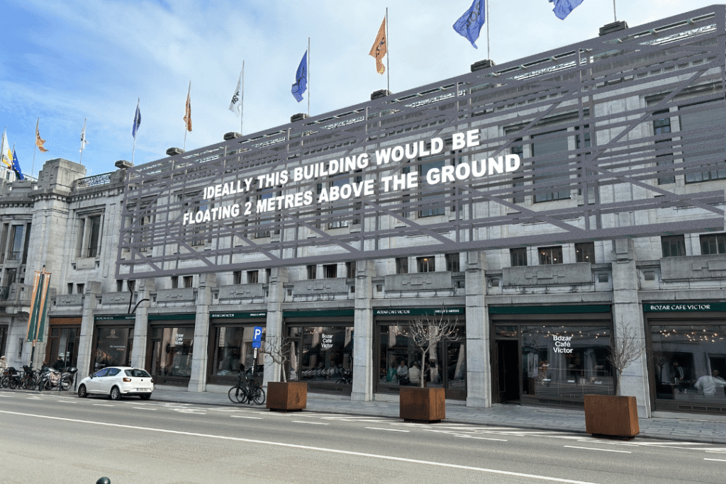 AR text artwork by Laure Prouvost on the façade of the Bozar building, reading 'Really this building would be floating 2 metres above the ground."
